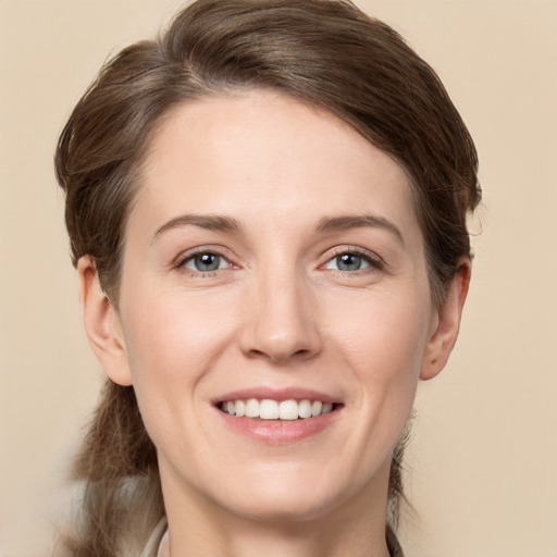 Joyful white young-adult female with long  brown hair and grey eyes