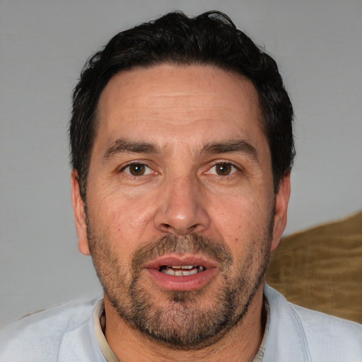 Joyful white adult male with short  black hair and brown eyes