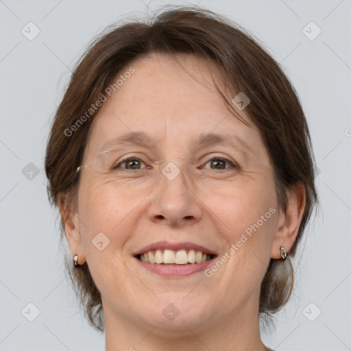 Joyful white adult female with medium  brown hair and grey eyes