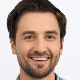 Joyful white young-adult male with short  brown hair and brown eyes