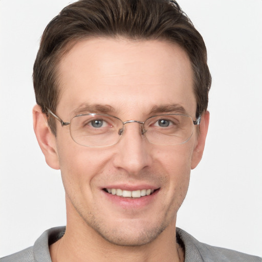 Joyful white adult male with short  brown hair and grey eyes