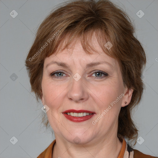 Joyful white adult female with medium  brown hair and blue eyes