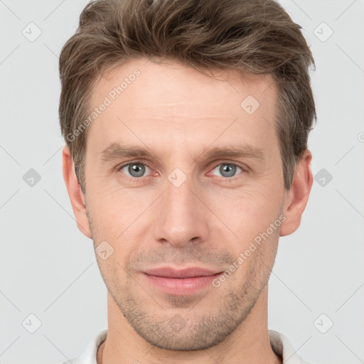 Joyful white young-adult male with short  brown hair and grey eyes