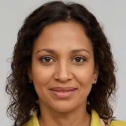 Joyful black adult female with medium  brown hair and brown eyes