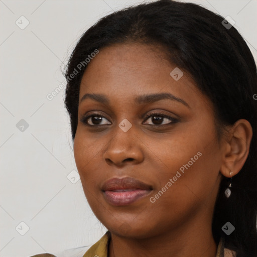 Joyful black young-adult female with long  black hair and brown eyes