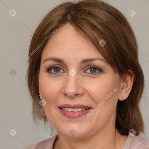 Joyful white adult female with medium  brown hair and blue eyes