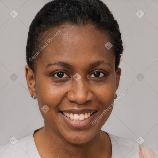 Joyful black young-adult female with short  brown hair and brown eyes