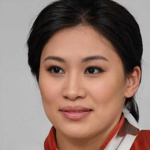Joyful asian young-adult female with medium  brown hair and brown eyes