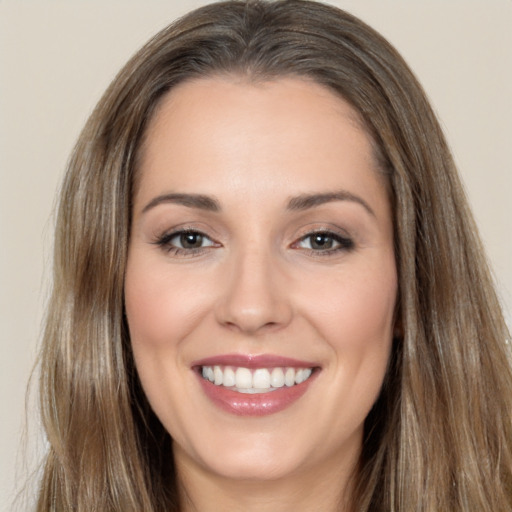 Joyful white young-adult female with long  brown hair and brown eyes