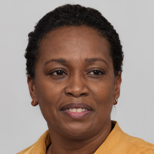 Joyful black adult female with short  brown hair and brown eyes