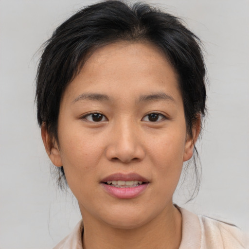 Joyful asian young-adult female with medium  brown hair and brown eyes