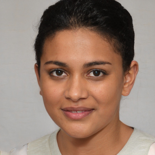 Joyful latino young-adult female with short  brown hair and brown eyes