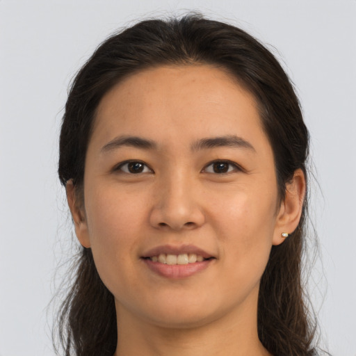Joyful asian young-adult female with long  brown hair and brown eyes