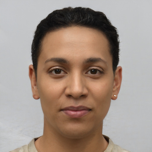 Joyful latino young-adult female with short  black hair and brown eyes