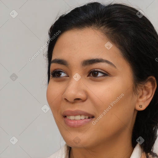 Joyful latino young-adult female with medium  brown hair and brown eyes