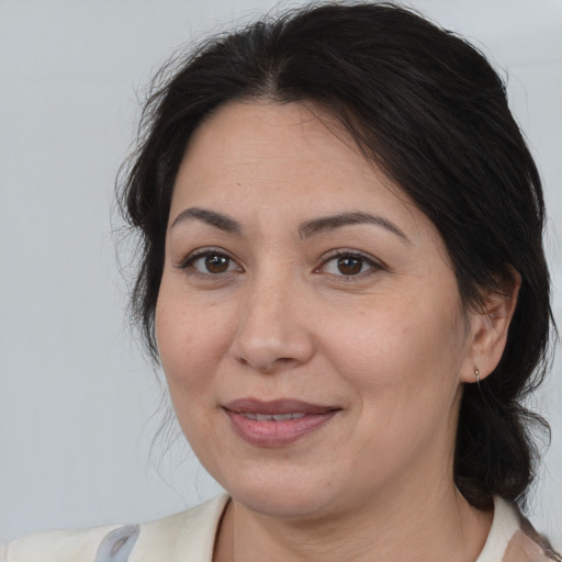 Joyful white adult female with medium  brown hair and brown eyes