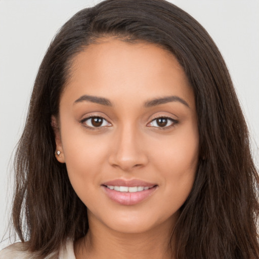 Joyful white young-adult female with long  brown hair and brown eyes