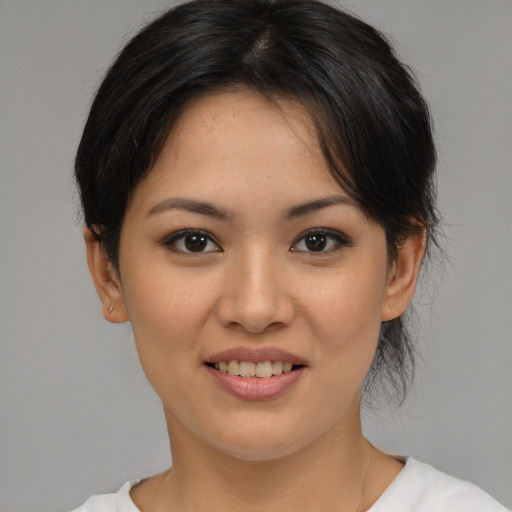 Joyful asian young-adult female with medium  brown hair and brown eyes