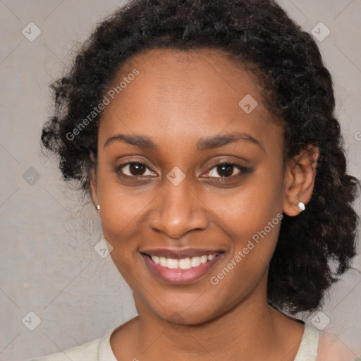 Joyful black young-adult female with medium  brown hair and brown eyes