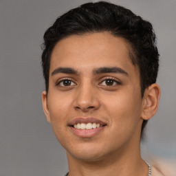 Joyful white young-adult male with short  black hair and brown eyes