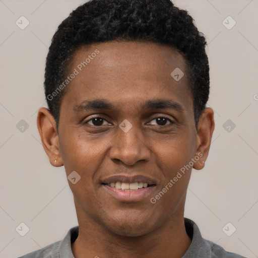 Joyful black young-adult male with short  black hair and brown eyes