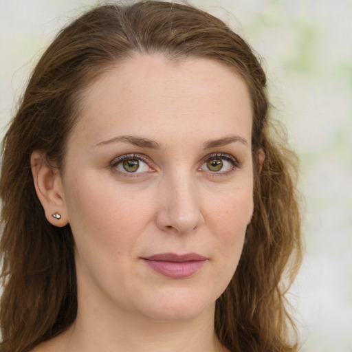 Joyful white young-adult female with long  brown hair and green eyes