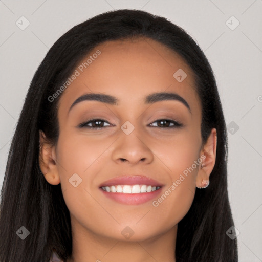 Joyful latino young-adult female with long  black hair and brown eyes