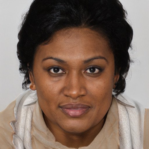 Joyful black adult female with medium  black hair and brown eyes
