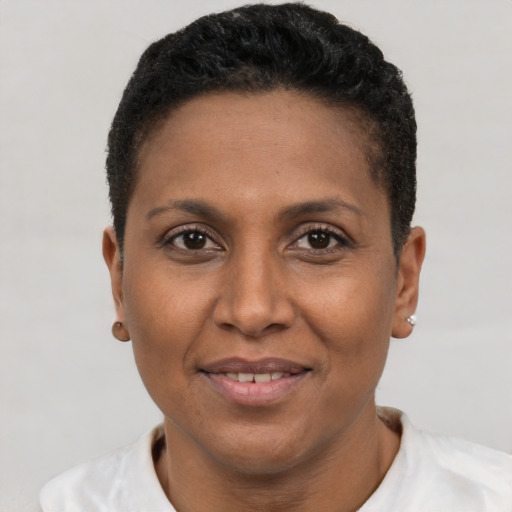 Joyful latino adult female with short  black hair and brown eyes