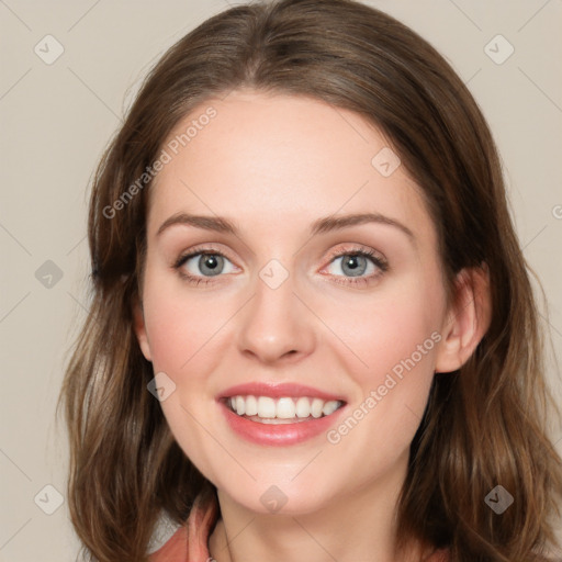 Joyful white young-adult female with long  brown hair and green eyes