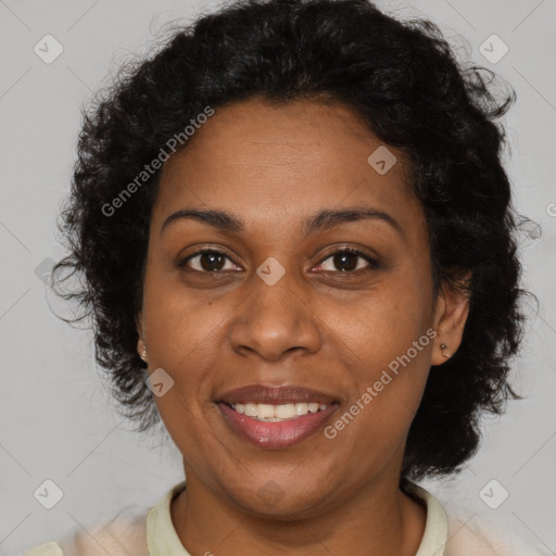 Joyful black adult female with short  brown hair and brown eyes