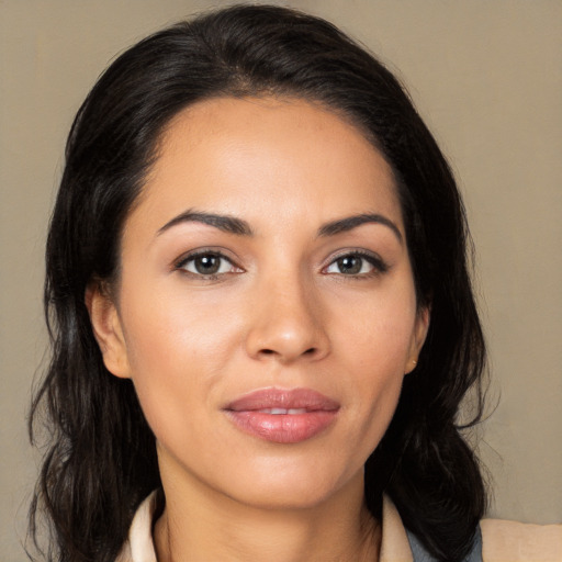 Joyful latino young-adult female with medium  brown hair and brown eyes