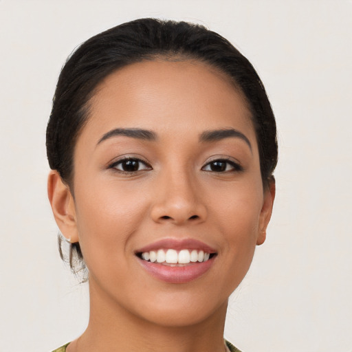 Joyful latino young-adult female with medium  brown hair and brown eyes