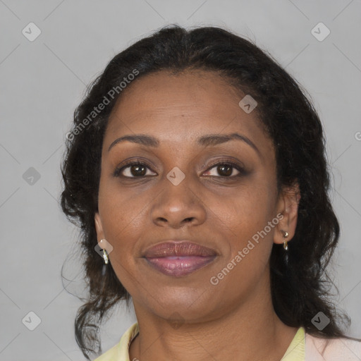 Joyful black adult female with medium  brown hair and brown eyes