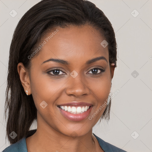 Joyful black young-adult female with long  brown hair and brown eyes