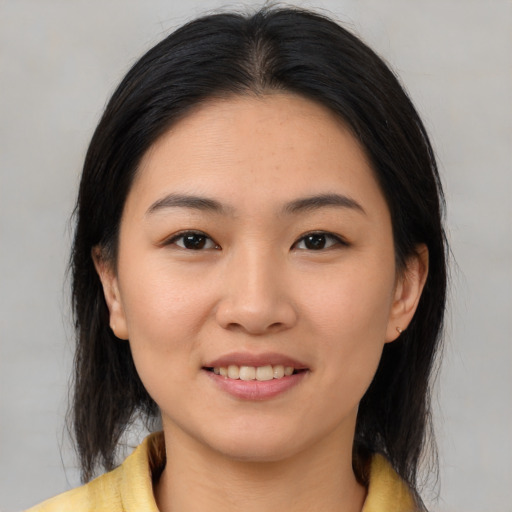 Joyful asian young-adult female with medium  brown hair and brown eyes