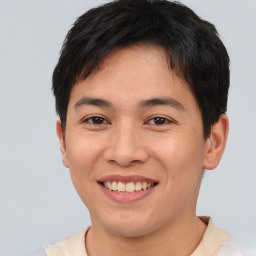 Joyful asian young-adult male with short  brown hair and brown eyes