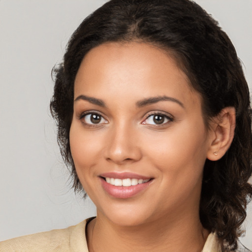 Joyful white young-adult female with medium  black hair and brown eyes