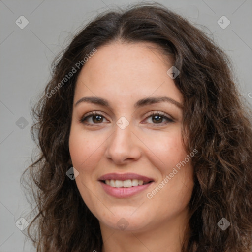 Joyful white adult female with long  brown hair and brown eyes