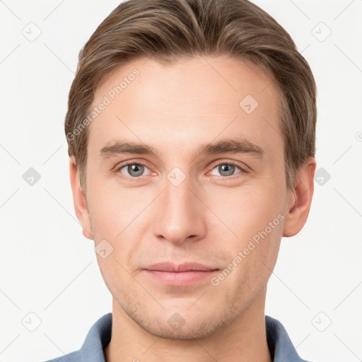 Joyful white young-adult male with short  brown hair and grey eyes