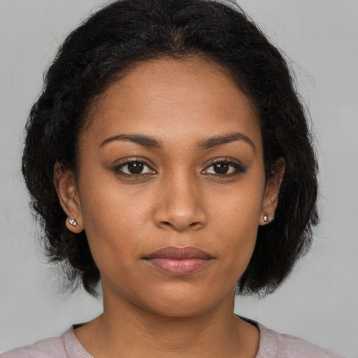 Neutral black young-adult female with medium  brown hair and brown eyes