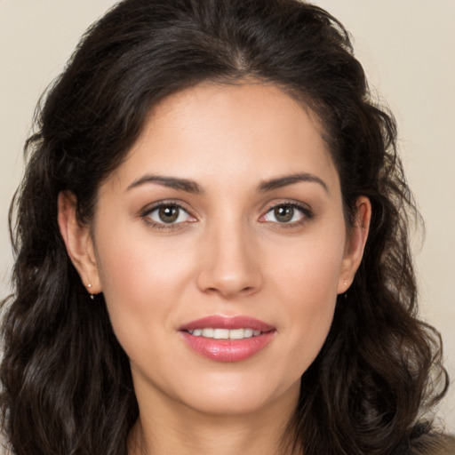 Joyful white young-adult female with long  brown hair and brown eyes