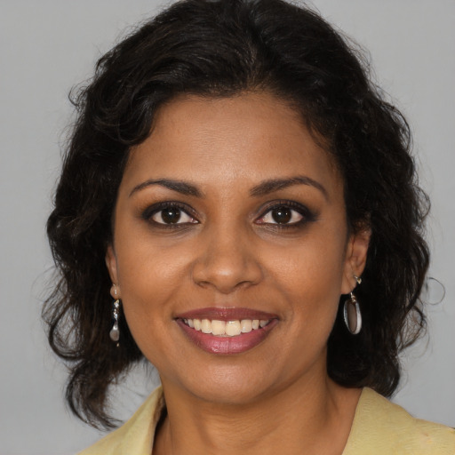 Joyful black young-adult female with medium  brown hair and brown eyes