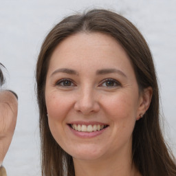 Joyful white adult female with long  brown hair and brown eyes