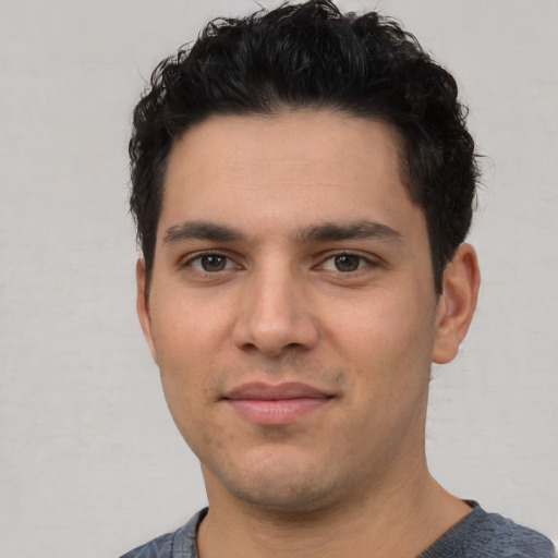 Joyful white young-adult male with short  black hair and brown eyes