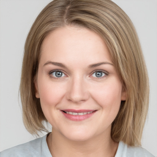 Joyful white young-adult female with medium  brown hair and blue eyes