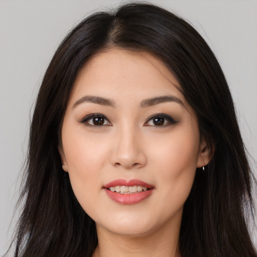Joyful asian young-adult female with long  brown hair and brown eyes