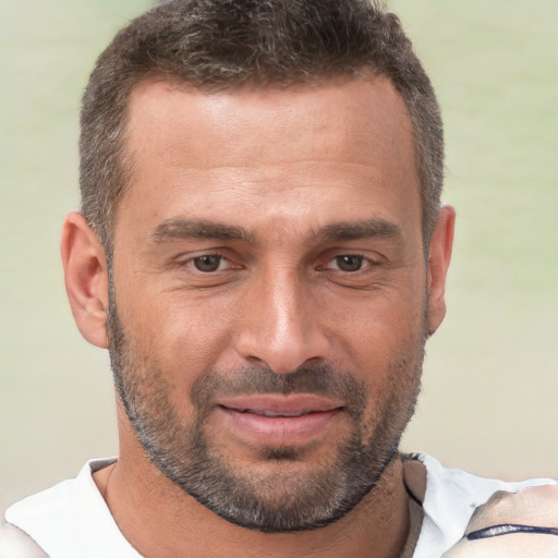 Joyful white adult male with short  brown hair and brown eyes