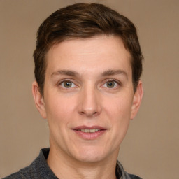 Joyful white adult male with short  brown hair and grey eyes