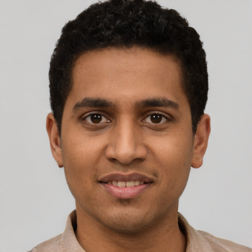 Joyful latino young-adult male with short  brown hair and brown eyes